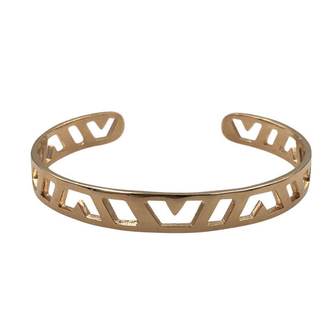 Gold hand carved cuff bracelet with geometric pattern on a white background 